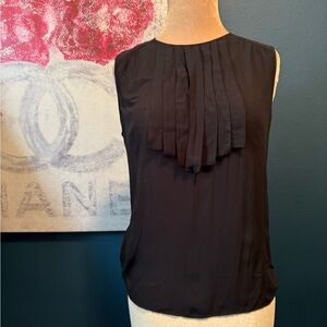 Vertigo Paris. Black sleeveless shell. Neck detail. Size small